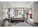 Luxurious Primary bedroom with a fireplace, large windows and a four-poster bed at 21487 N 110Th Pl, Scottsdale, AZ 85255