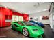Garage with red cabinets and luxury cars at 21487 N 110Th Pl, Scottsdale, AZ 85255