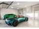 Garage with teal Aston Martin and green SUV at 21487 N 110Th Pl, Scottsdale, AZ 85255