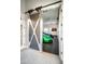 Garage with unique sliding door and luxury cars at 21487 N 110Th Pl, Scottsdale, AZ 85255