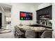 Curved home bar with a large TV and ample seating at 21487 N 110Th Pl, Scottsdale, AZ 85255