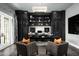 Luxurious home office with built-in dark wood cabinetry and two armchairs at 21487 N 110Th Pl, Scottsdale, AZ 85255
