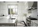 Modern kitchen with white cabinets, marble countertops, and a stylish sink at 21487 N 110Th Pl, Scottsdale, AZ 85255