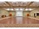 Large community room with hardwood floors and a stage perfect for events at 2608 E Desert Wind Dr, Casa Grande, AZ 85194