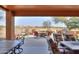 Covered patio with comfortable seating and a fire pit at 2608 E Desert Wind Dr, Casa Grande, AZ 85194