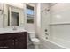 Bathroom features a bathtub, shower, vanity with storage, and updated fixtures at 2828 N Evergreen St, Buckeye, AZ 85396