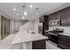 Open kitchen design featuring stainless steel appliances, a modern island, and pendant lighting at 2828 N Evergreen St, Buckeye, AZ 85396