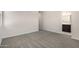 Spacious bedroom with neutral walls and carpeting, showcasing a walk-through to the bathroom at 2828 N Evergreen St, Buckeye, AZ 85396