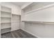 Spacious walk-in closet features built-in shelving and wooden rods for ample storage at 2828 N Evergreen St, Buckeye, AZ 85396