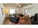 Warm living room featuring exposed beam ceilings, comfortable furniture, and French doors to the outside at 3142 N 27Th St, Phoenix, AZ 85016