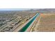 Aerial view of homes and desert landscape with canal at 31983 N 124Th Dr, Peoria, AZ 85383