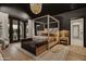 Luxurious main bedroom with four-poster bed, sitting area, and backyard access at 3827 E Marlette Ave, Paradise Valley, AZ 85253