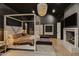Modern bedroom with a canopy bed, statement lighting, and a cozy fireplace at 3827 E Marlette Ave, Paradise Valley, AZ 85253
