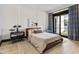 Spacious bedroom with a leather bed and patio access at 3827 E Marlette Ave, Paradise Valley, AZ 85253