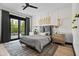 Stylish bedroom with a gray bed, wood accents, and access to the backyard at 3827 E Marlette Ave, Paradise Valley, AZ 85253