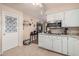 Cozy kitchen with white cabinets, stainless steel microwave, and tile flooring at 5433 E Dodge St, Mesa, AZ 85205