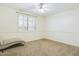 Bedroom with a ceiling fan, carpet, plantation shutter, and a chaise lounge at 5613 W West Wind Dr, Glendale, AZ 85310