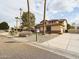 Two-story home featuring desert landscaping, a basketball hoop, and a private driveway at 5613 W West Wind Dr, Glendale, AZ 85310