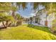 Backyard with grassy area, pool, and palm trees at 7605 S 18Th Way, Phoenix, AZ 85042