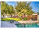 Landscaped backyard with seating area near pool at 7605 S 18Th Way, Phoenix, AZ 85042