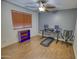 Bedroom with tile floor, desk, and treadmill at 7605 S 18Th Way, Phoenix, AZ 85042