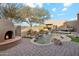 Stunning custom pool with waterfall features, a fireplace, and desert landscaping at 8220 E Cavalry Dr, Scottsdale, AZ 85266