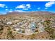 Stunning aerial view of a home with solar panels, a pool, and mountain views in the background at 8479 E Sunrise Sky Dr, Gold Canyon, AZ 85118