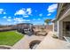 Large backyard features artificial turf, a paved patio, a pergola with seating, and a fire pit at 8479 E Sunrise Sky Dr, Gold Canyon, AZ 85118