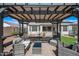 Covered backyard patio with comfortable seating and views of the fenced yard at 8479 E Sunrise Sky Dr, Gold Canyon, AZ 85118