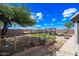 Expansive backyard includes garden beds, a pergola with seating, desert landscaping, and plenty of space at 8479 E Sunrise Sky Dr, Gold Canyon, AZ 85118