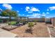 Spacious backyard includes garden beds, a pergola with seating, desert landscaping, and privacy fence at 8479 E Sunrise Sky Dr, Gold Canyon, AZ 85118