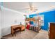 bedroom featuring a bunk bed, desk, and blue accent wall at 8479 E Sunrise Sky Dr, Gold Canyon, AZ 85118