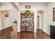 Elegant entryway featuring an arched doorway, a decorative bookshelf and hardwood floors at 8479 E Sunrise Sky Dr, Gold Canyon, AZ 85118