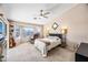 Cozy main bedroom with large windows, a ceiling fan, and natural light at 8479 E Sunrise Sky Dr, Gold Canyon, AZ 85118