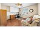 Comfortable home office with built-in storage and a cozy sofa at 8479 E Sunrise Sky Dr, Gold Canyon, AZ 85118