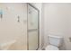 Bright bathroom featuring a tiled shower with glass door, and white toilet at 9270 E Mission Ln # 117, Scottsdale, AZ 85258