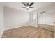 Neutral bedroom with a ceiling fan, wood-look tile floors, and sliding mirror closet doors at 9270 E Mission Ln # 117, Scottsdale, AZ 85258