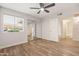 Bright bedroom featuring wood-look tile floors and sliding mirror closet doors at 9270 E Mission Ln # 117, Scottsdale, AZ 85258