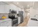 Bright kitchen with stainless steel appliances, white cabinets, and quartz countertops at 9270 E Mission Ln # 117, Scottsdale, AZ 85258