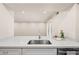 Modern kitchen sink with quartz countertop, stainless steel faucet, and bright lighting at 9270 E Mission Ln # 117, Scottsdale, AZ 85258