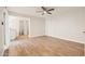Spacious main bedroom with wood-look tile flooring, ceiling fan, and attached bathroom at 9270 E Mission Ln # 117, Scottsdale, AZ 85258