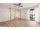 Spacious main bedroom with wood-look tile flooring, sliding glass door, and walk-in closet at 9270 E Mission Ln # 117, Scottsdale, AZ 85258
