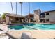 Sparkling community pool with a covered area for shade and convenience, surrounded by well-kept landscaping at 9270 E Mission Ln # 117, Scottsdale, AZ 85258