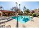 Beautiful pool area with lounge chairs and covered seating, surrounded by lush landscaping at 9270 E Mission Ln # 117, Scottsdale, AZ 85258