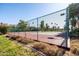 Community tennis court with green fencing and mature trees, located in a well-kept residential area at 9270 E Mission Ln # 117, Scottsdale, AZ 85258