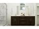 Modern bathroom with dark wood cabinets, a double vanity, and a large shower at 10154 E Ursula Ave, Mesa, AZ 85212