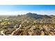 An aerial view of a desert community with mountain views and a golf course at 10306 E Rising Sun Pl, Gold Canyon, AZ 85118