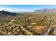 Scenic community aerial view showcasing a golf course and surrounding mountains at 10306 E Rising Sun Pl, Gold Canyon, AZ 85118