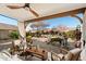 Outdoor patio with a ceiling fan, seating area, and scenic views of the landscaped yard at 10306 E Rising Sun Pl, Gold Canyon, AZ 85118