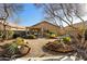 View of landscaped backyard with outdoor seating and patio at 10306 E Rising Sun Pl, Gold Canyon, AZ 85118